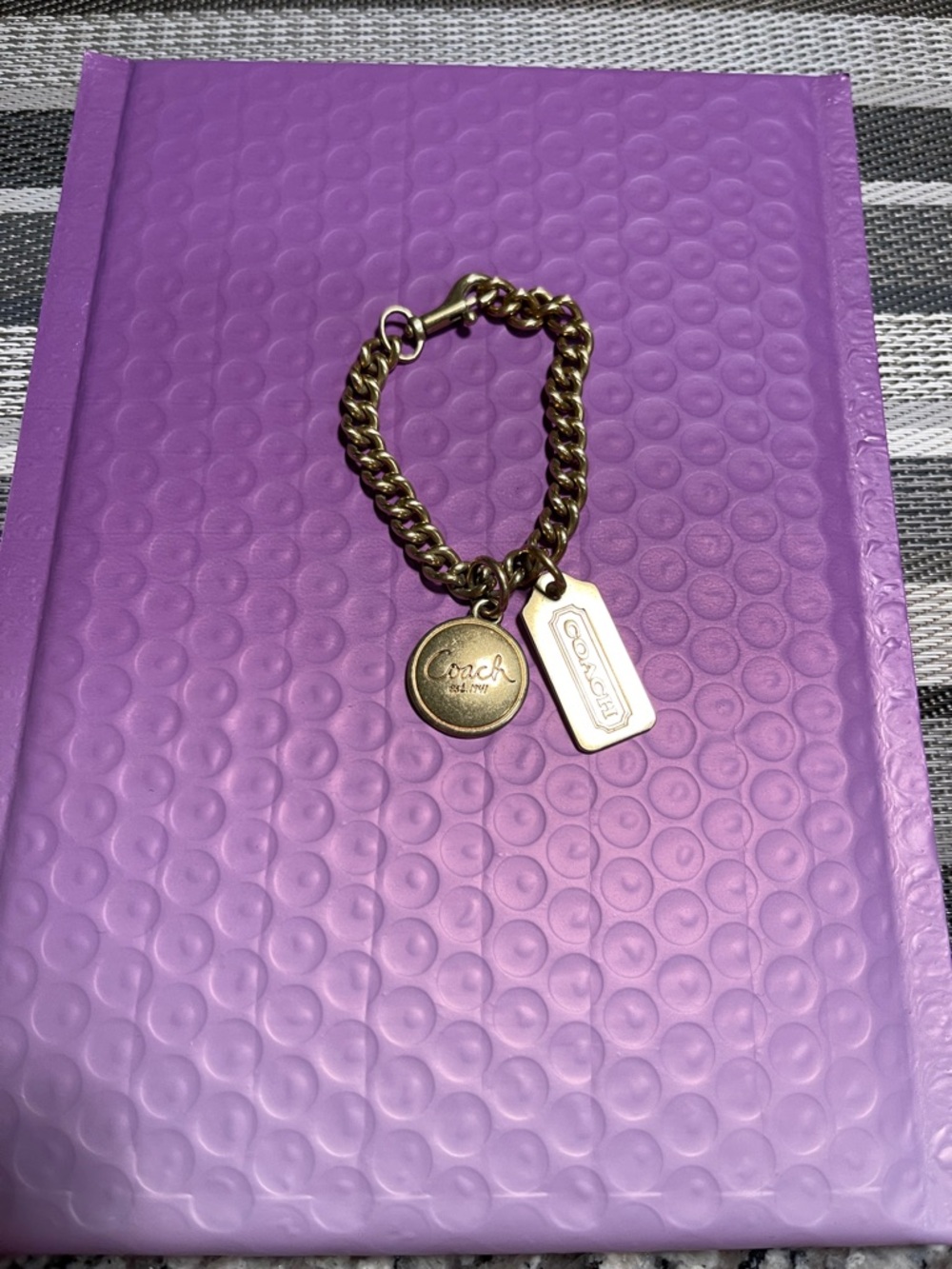 Coach Gold-Tone Link Logo Charms or bracelet.